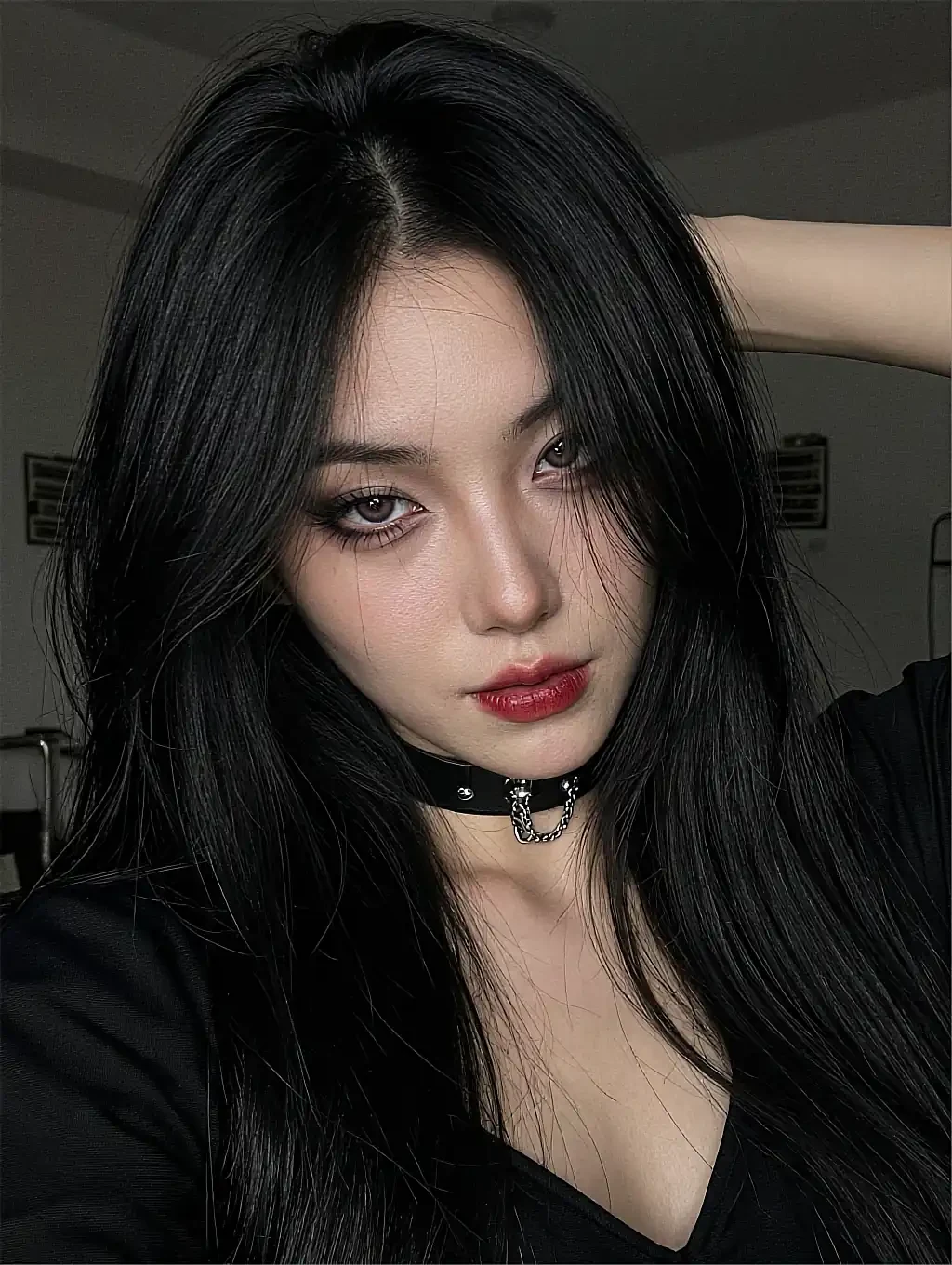 Free-tier folder: a fictional AI character with black hair and a choker, arm raised indoors